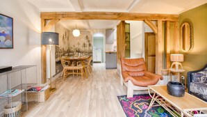 A spacious living area with a dining table, a leather armchair, and a sofa. - Villa Bougainvillier - quays of Trouville-sur-Mer (Trouville-sur-Mer)