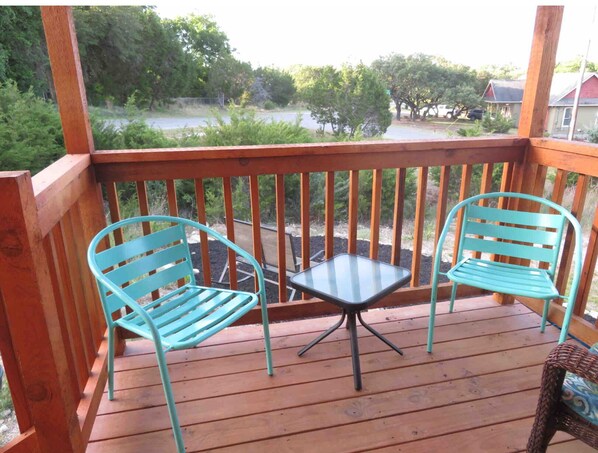 Enjoy a peaceful retreat on the deck with a bathtub and comfortable seating for two.
