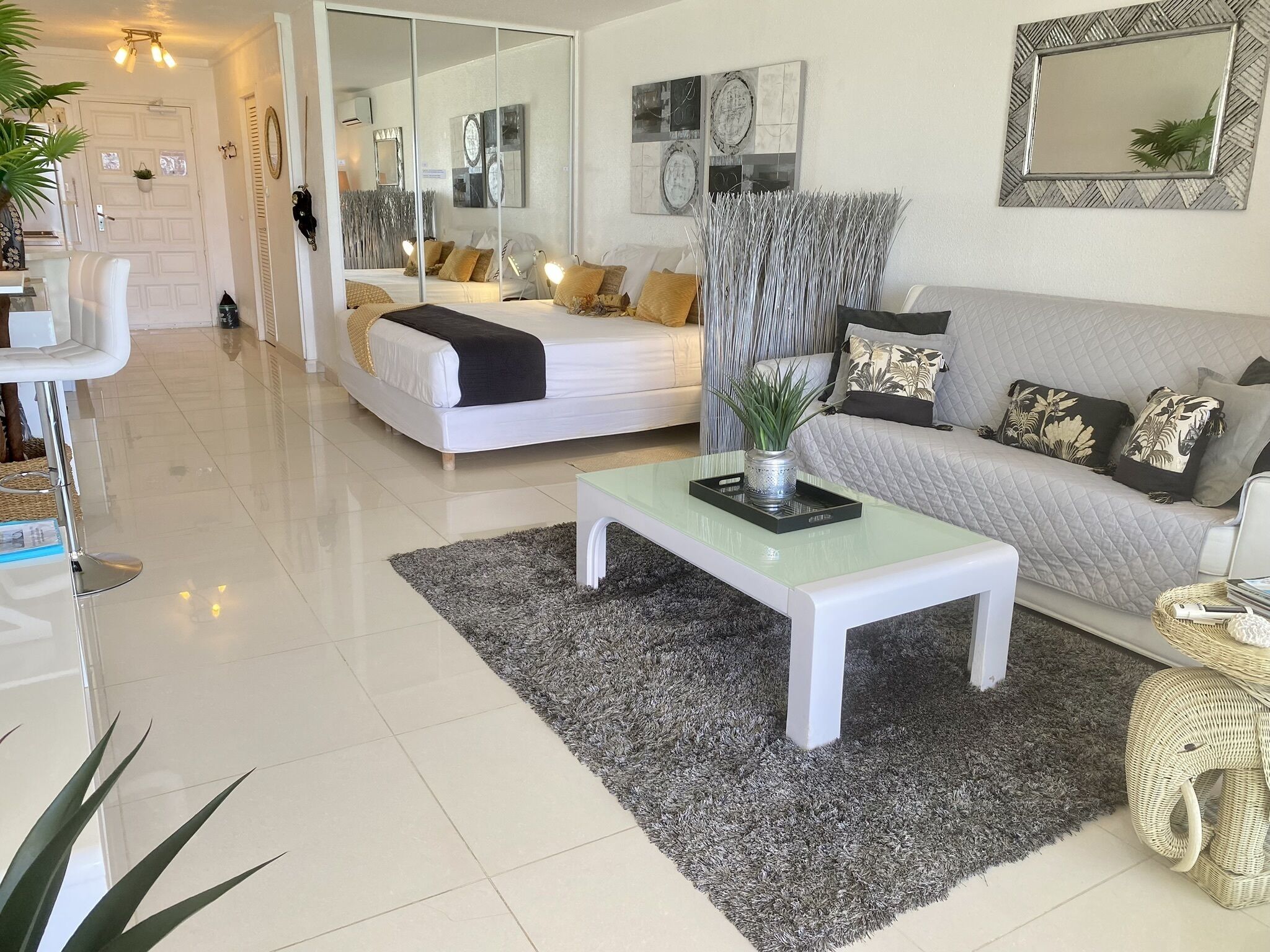 A modern living room with a bed, sofa, and a coffee table.