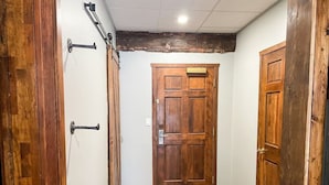 A hallway with wooden doors and a wooden floor. - Apex Mountain ~ Precision Palace ~ Apex Mountain Inn (Apex Mountain Resort)