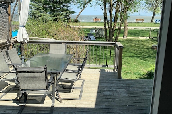 view of the lake from the front deck, features table with seating for six
