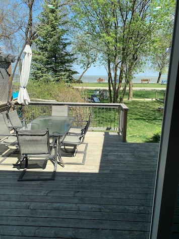 view of the lake from the front deck, features table with seating for six