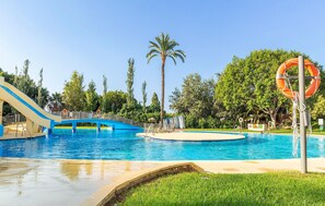 A swimming pool with a blue slide and a lifebuoy. - 1 bedroom nice apartment in Benalmadena (Benalmadena)