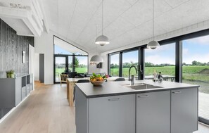 Enjoy meals in the spacious kitchen with a large island and dining area offering a view of the surrounding landscape.