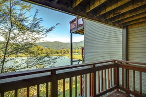A wooden deck with a view of a lake and mountains. - Walk to Ski/Tennis Mountain Condo with Golf Course View (Sugar Mountain)