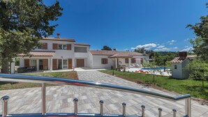 A modern two-story house with a tiled roof, a swimming pool, and a well-maintained garden. - Gorgeous home in Labin (Labin)