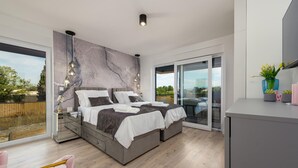 A modern bedroom with a large bed, a glass door leading to a balcony, and a minimalist design. - Awesome home in Zaton (Zaton)