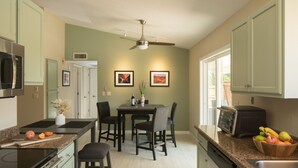 A kitchen with a dining area, a microwave, a toaster, and a fruit bowl. - Pool, Hot tub, Fire Pit, BBQ ~  Beautiful home with patio living at it's best! (Cottonwood)