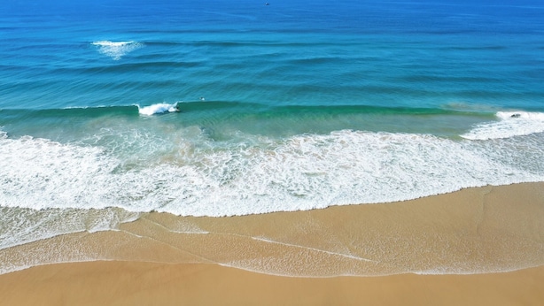 A beach with clear blue water and waves. - Spindrift Lowerdeck BEACH FRONT location! Retro style 2 bed, Wifi, Nespresso++++ (Yamba)