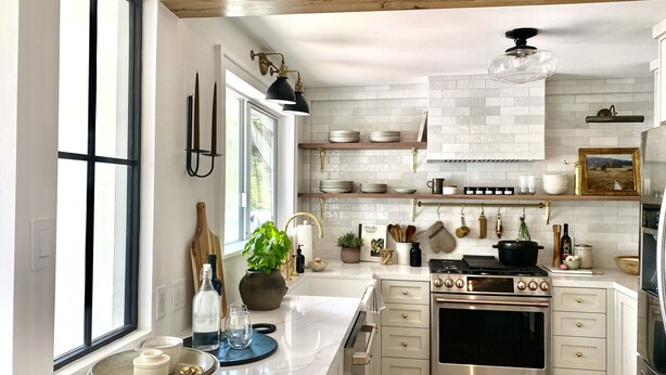 A modern kitchen with white cabinetry, a large island, and stainless steel appliances. - THE Zen Treehouse Retreat- Great Views and Peaceful Decks!
 (Los Angeles)