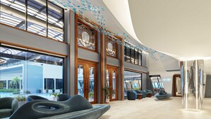 A spacious lobby with modern seating, large windows, and a high ceiling. - The Oceanic Sportel Phuket - SHA Extra Plus (Ko Kaeo)