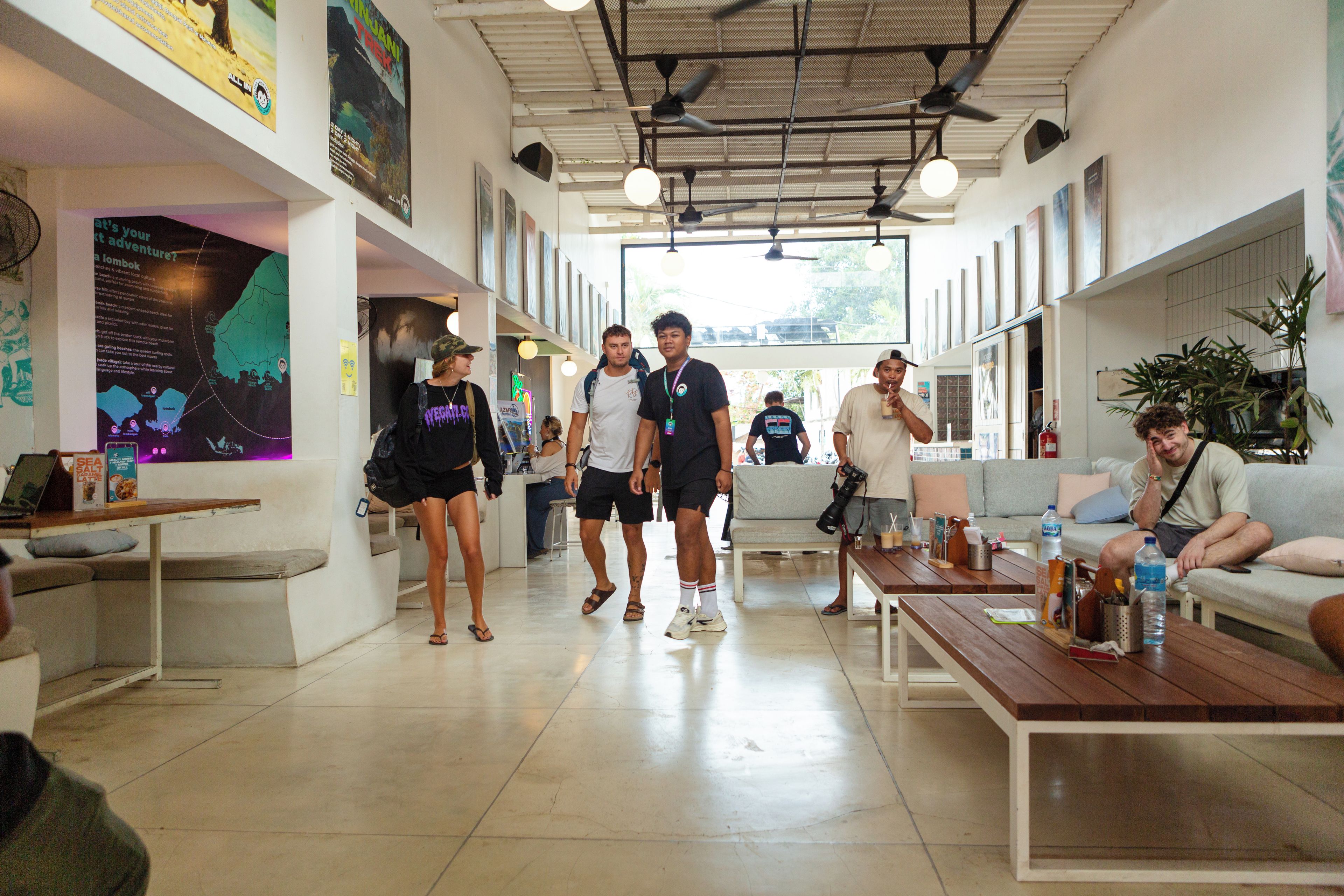 A spacious indoor area with seating arrangements, a counter, and various informational posters on the walls.