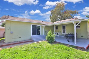 Guests can dine or relax on the front porch with a table and chairs.