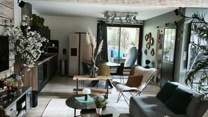 A modern living room with a sofa, coffee table, and dining area.