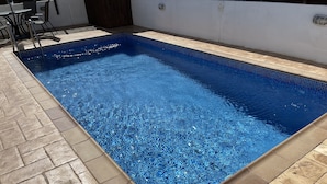 A rectangular swimming pool with clear blue water, surrounded by a tiled deck. - Beautiful Villa With Pool in Ayia Triada, Cyprus (Paralimni)