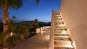 A staircase with patterned tiles leading to a balcony overlooking a mountainous landscape at dusk. - Cozy home in Partinico (Partinico)
