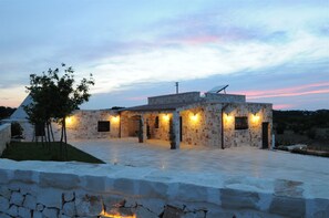 A stone building with multiple rooms and a covered outdoor area, surrounded by a stone wall and a small tree. - New Fabulous Villa Fichi Private Pool, private terrace WIFi (Martina Franca)