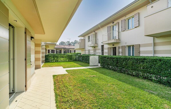 A residential building with a covered walkway, a well-maintained lawn, and a hedge. - Nice home in Puegnago sul garda with WiFi (Puegnago sul garda)