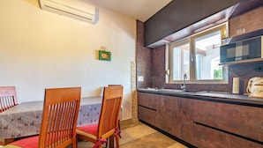 A compact kitchen with dark cabinets, a stainless steel sink, and a window providing natural light. - Awesome apartment in Vir with WiFi (Vir)