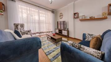 Luxury Apartment, 3 Bedrooms | Living area | Flat-screen TV