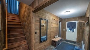 A wooden interior with a staircase, a bench, a door, and a mirror. - Large family & pet friendly home! Huge outdoor playset, backyard games & more!  (Wilmington)