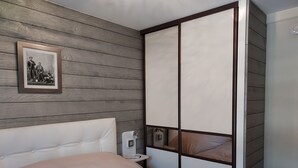 A bedroom with a bed, a nightstand, a wardrobe, and a framed picture on the wall. - 200 m from the Saint Gervais les Bains cable car  (Saint-Gervais-les-Bains)