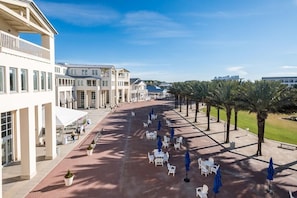 A spacious outdoor area with multiple seating arrangements and a clear view of the surrounding buildings.