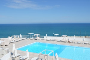 Piscina externa sazonal, funciona das 9h30 às 19h, guarda-sóis