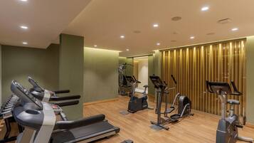 A gym with treadmills, elliptical machines, and stationary bikes.