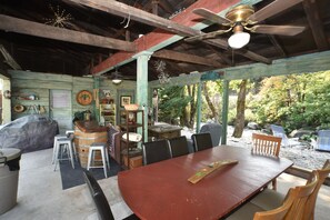 A rustic wooden dining area with a large table, chairs, and a ceiling fan. - ❤Riverfront Paradise - Butterfly Ranch on the River❤ (Dunsmuir)