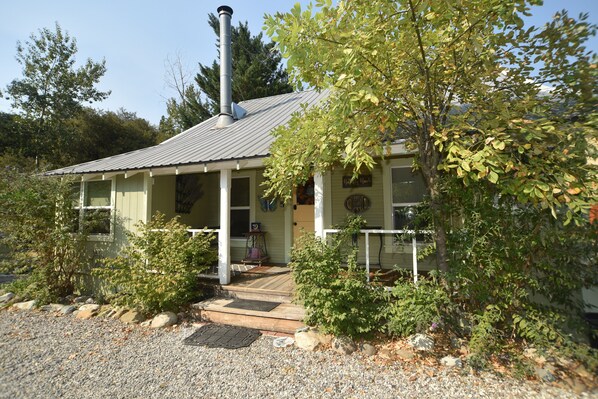 A single-story building with a porch, a chimney, and a gravel driveway. - ❤Riverfront Paradise - Butterfly Ranch on the River❤ (Dunsmuir)