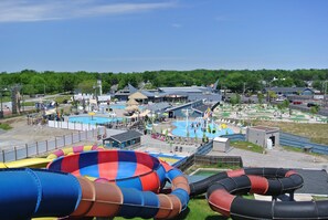 A water park with multiple slides and a swimming pool.