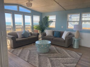 A living room with two sofas, a patterned coffee table, and a lamp.