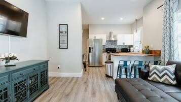 House (614 S. Converse St (Right Side)) | Living room | Flat-screen TV, books