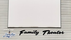 A blank whiteboard on a wall with horizontal lines, labeled "Family Theater" at the bottom.