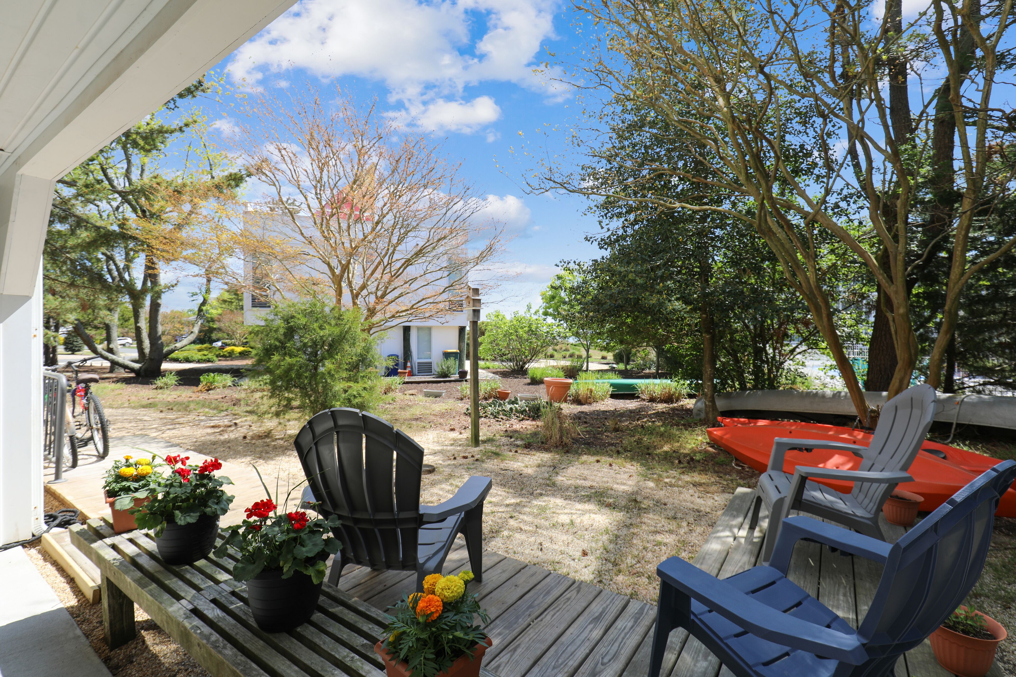 A wooden deck with outdoor seating and potted plants.