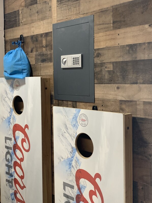 Two large wooden boxes with a Coca-Cola logo and a Coors Light logo, mounted on a wooden wall. - Secluded Cabin w/ Private Pond/ Peaceful Getaway (Cameron Mills)