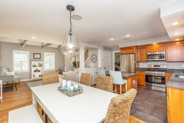 Enjoy cooking in the well-equipped kitchen with a central island, oven, and refrigerator.