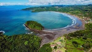 An aerial view of a coastal area with a beach, a small island, and lush greenery. - 4-6 guests, 5 Beds / 2.5 Baths • Private Villa / Beachfront Pool & Club (Las Escobas del Venado)