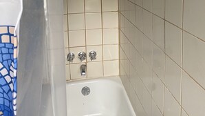 A bathroom with a bathtub, a shower, and a tiled wall with a decorative border. - Apt near Temple, St. Christ, Jean, Abington  (Philadelphia)