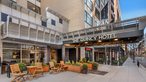 The Quincy Hotel with outdoor seating, a modern facade, and a clear sky. - The Quincy, an Ascend Collection Hotel (Washington)