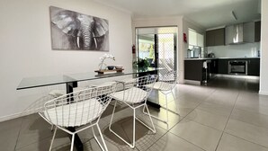 A modern kitchen with a dining area.