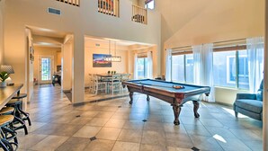 A spacious living area with a pool table, a dining area, and a balcony with a view. - Walk to Surprise Stadium! Villa w/ Outdoor Oasis (Surprise)