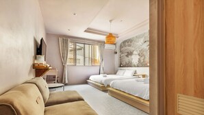 A modern bedroom with a sofa, two beds, a window with curtains, a wall-mounted TV, and a decorative mural. - Lane 32 (Tainan)