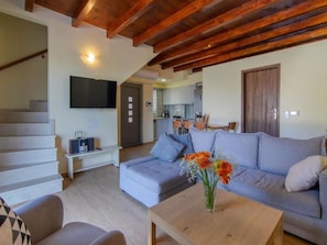 Relax in this stylish living space with a sofa, coffee table, and flat-screen TV.
