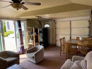 Relax in this spacious room with a sliding glass door leading to an outdoor area and a comfortable seating area.
