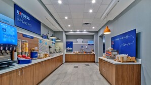 A modern breakfast area with a coffee machine, cereal dispensers, and a bakery section.