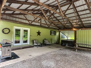 A covered patio area with a metal roof, a green wall, and a star decoration.