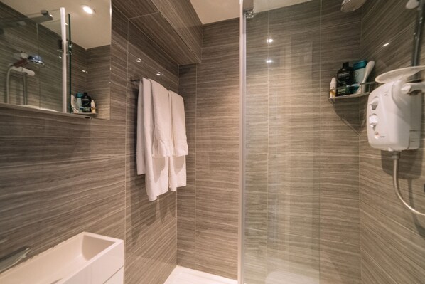 Shower, hair dryer, towels, toilet paper