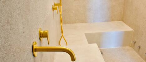 A bathroom with a bathtub, a shower, and a sink.